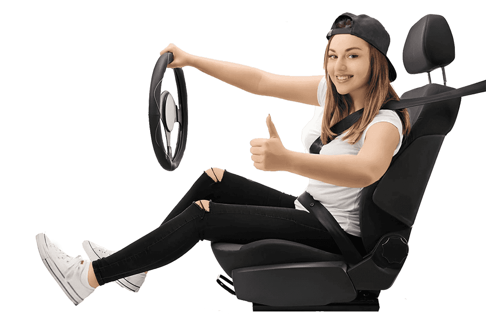 A student sitting on a car seat, holding a steering wheel