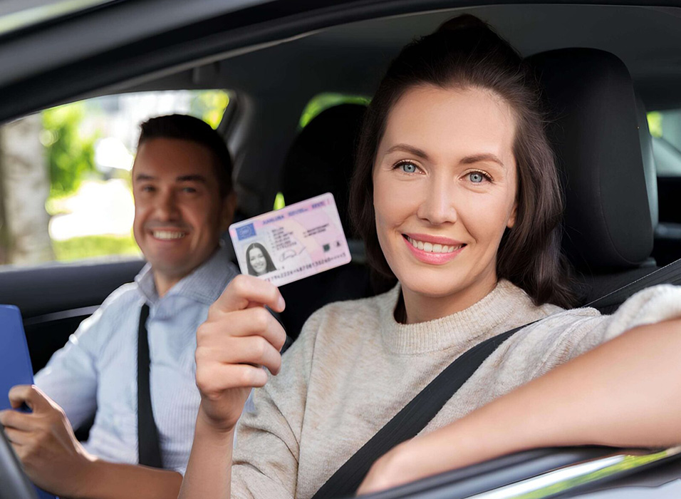 A driving student holding her licence passed her test using the UNO Driving School fast-track course.